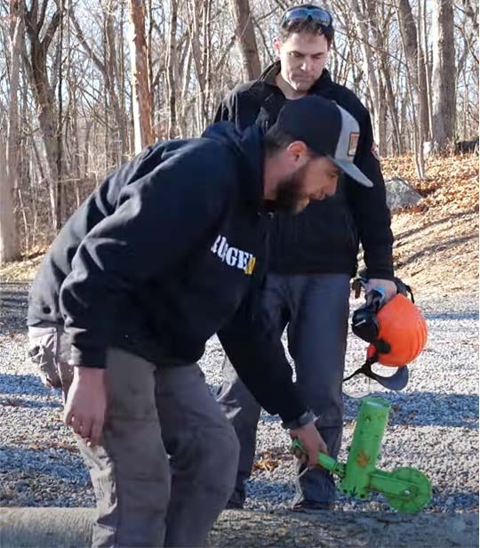 Man marking a tree outside